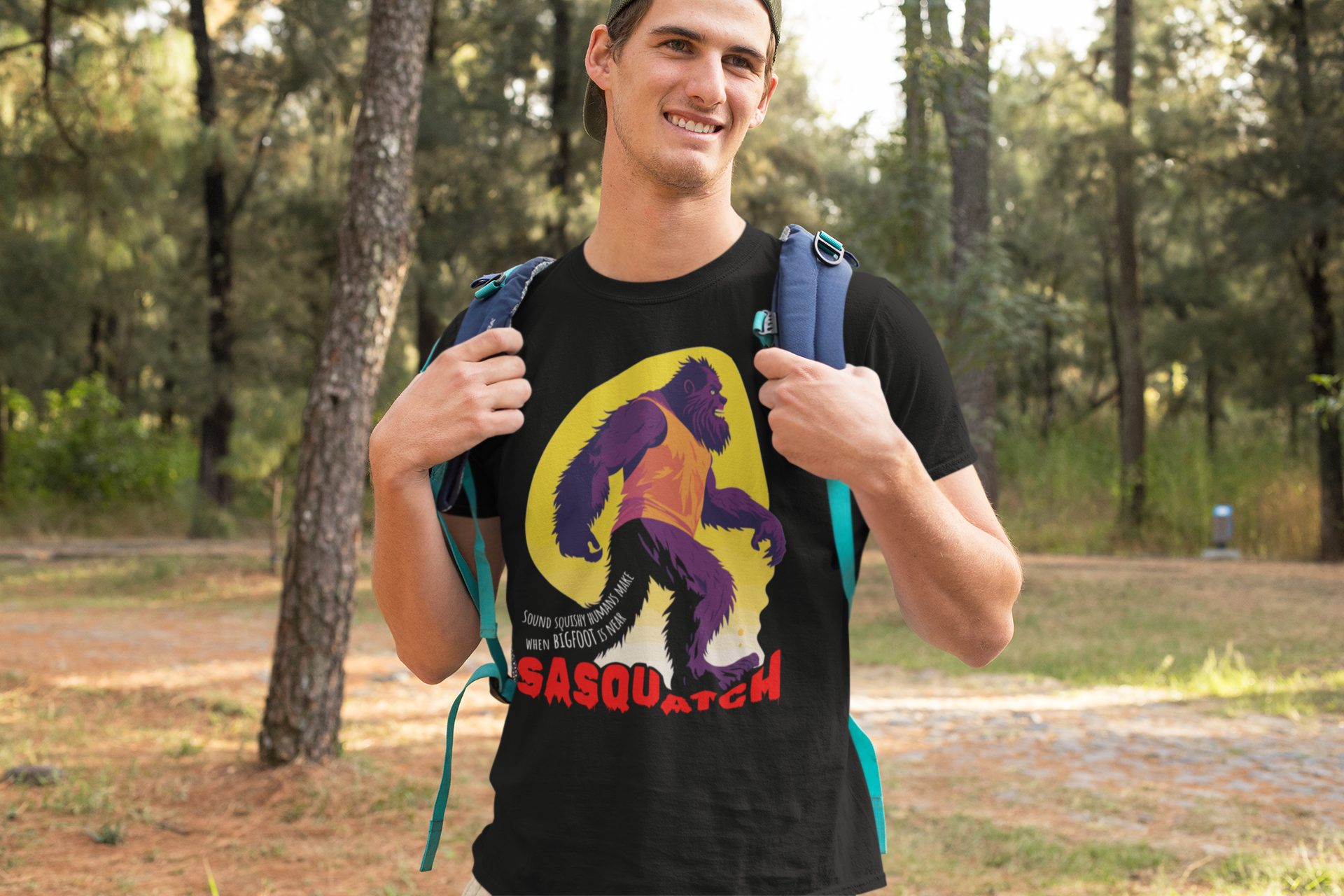 Backpacker wearing the SASQUATCH shirt in a forrest.